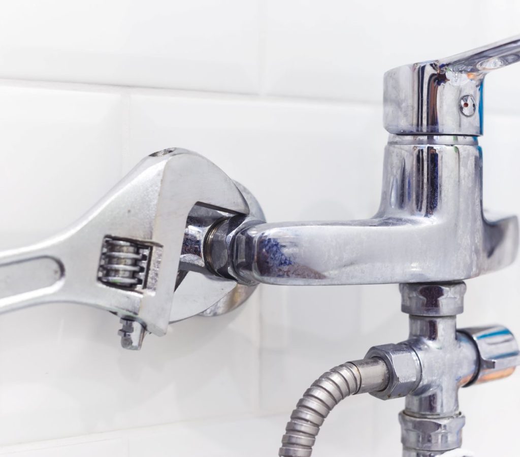 gloved-hand-tightening-plumbing-fixture-with-adjus-2026-03-19-23-08-25-utc