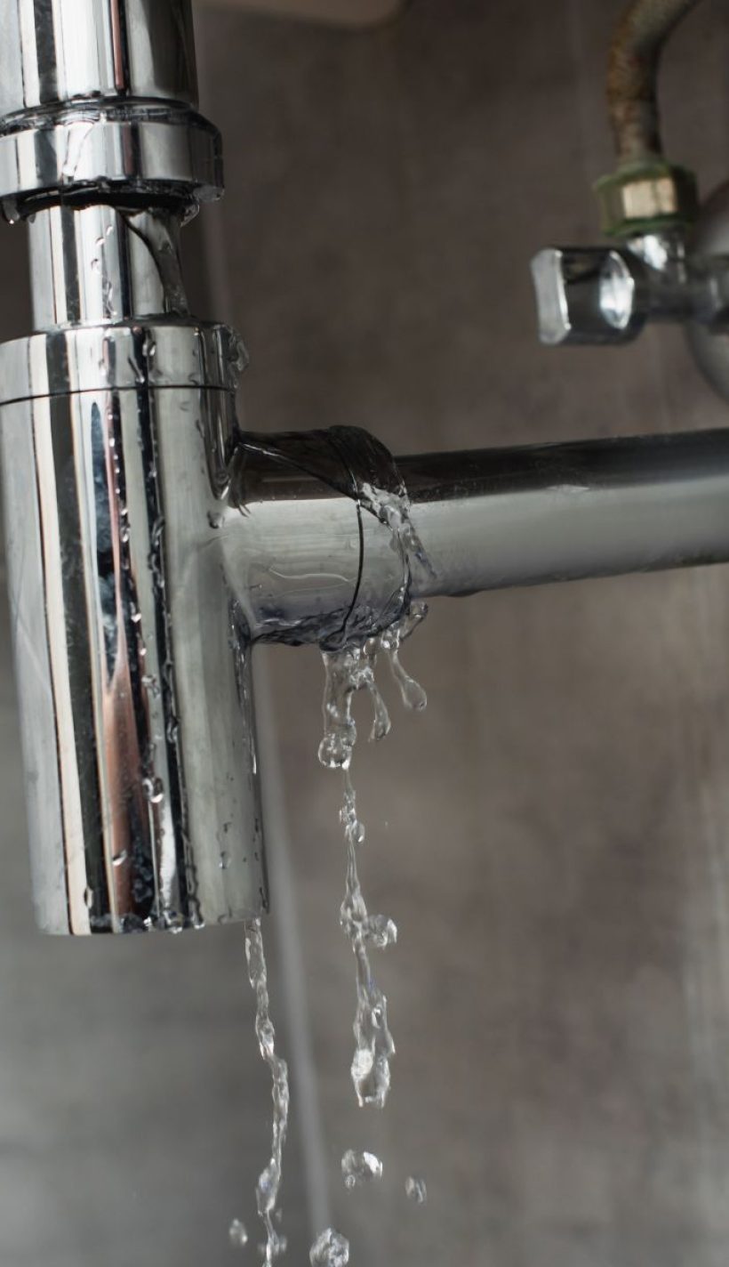 leaky-chrome-pipe-with-water-damage-on-wall-2026-03-12-23-52-28-utc